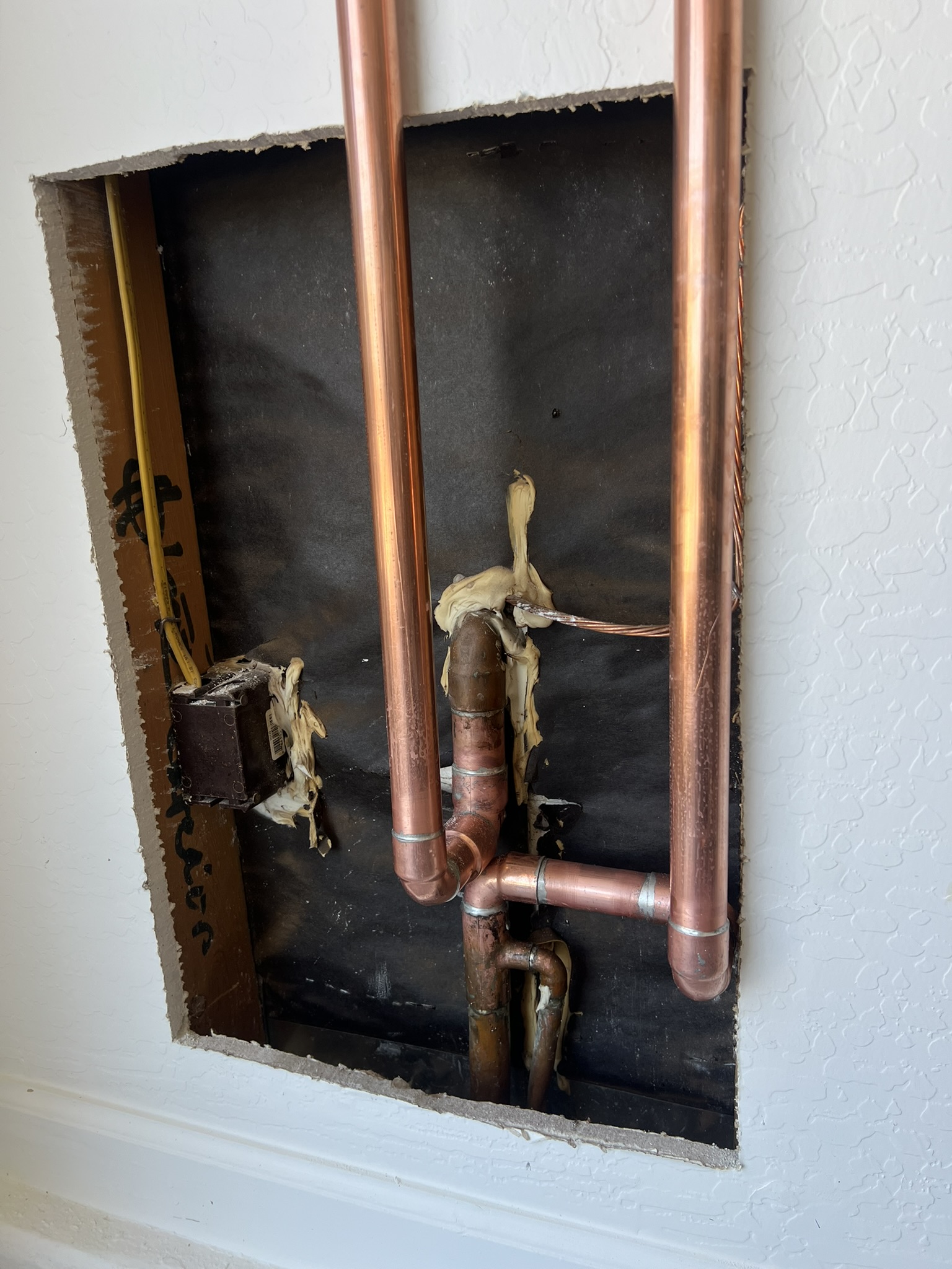 Fresh copper pipe rerun in wall cutout