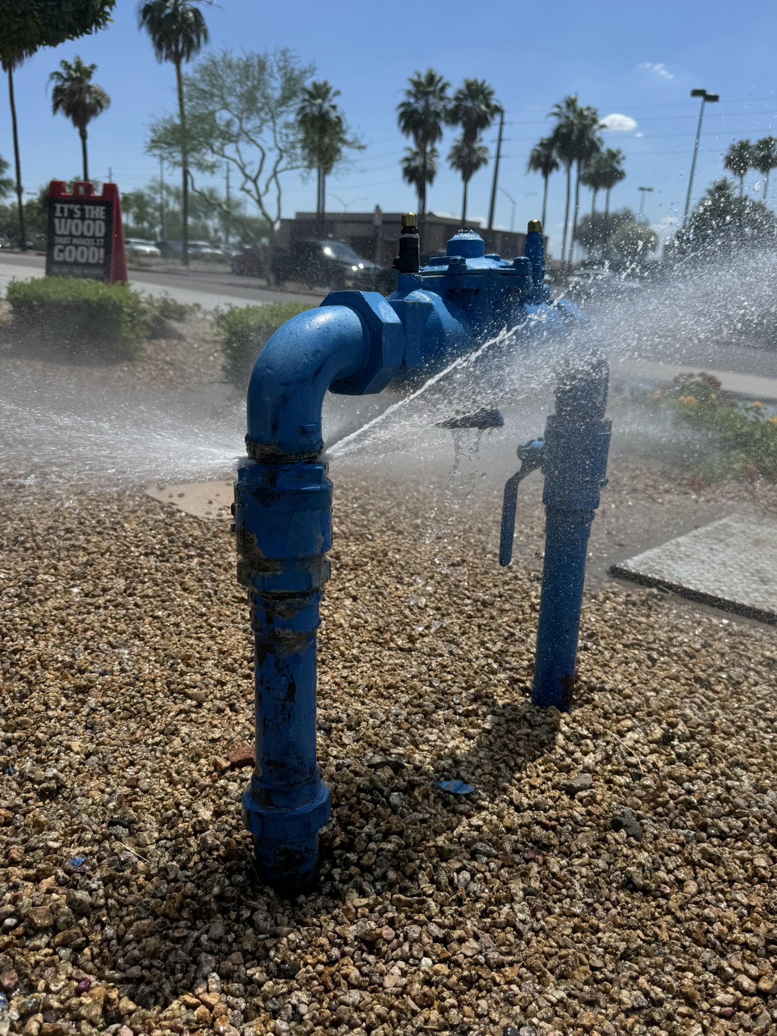 Burst water main spraying — emergency plumbing call
