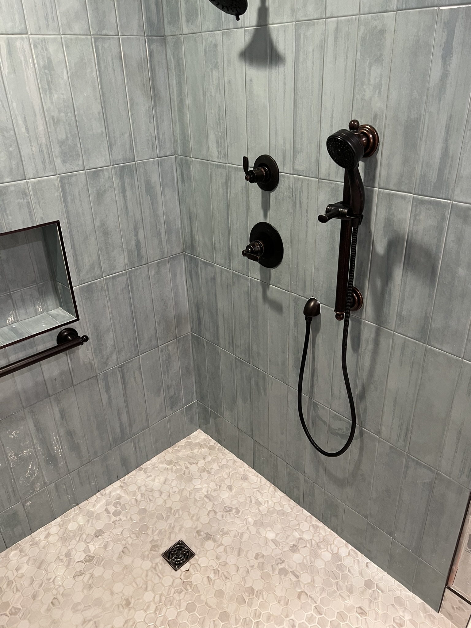 Finished tile shower with oil-rubbed bronze fixtures