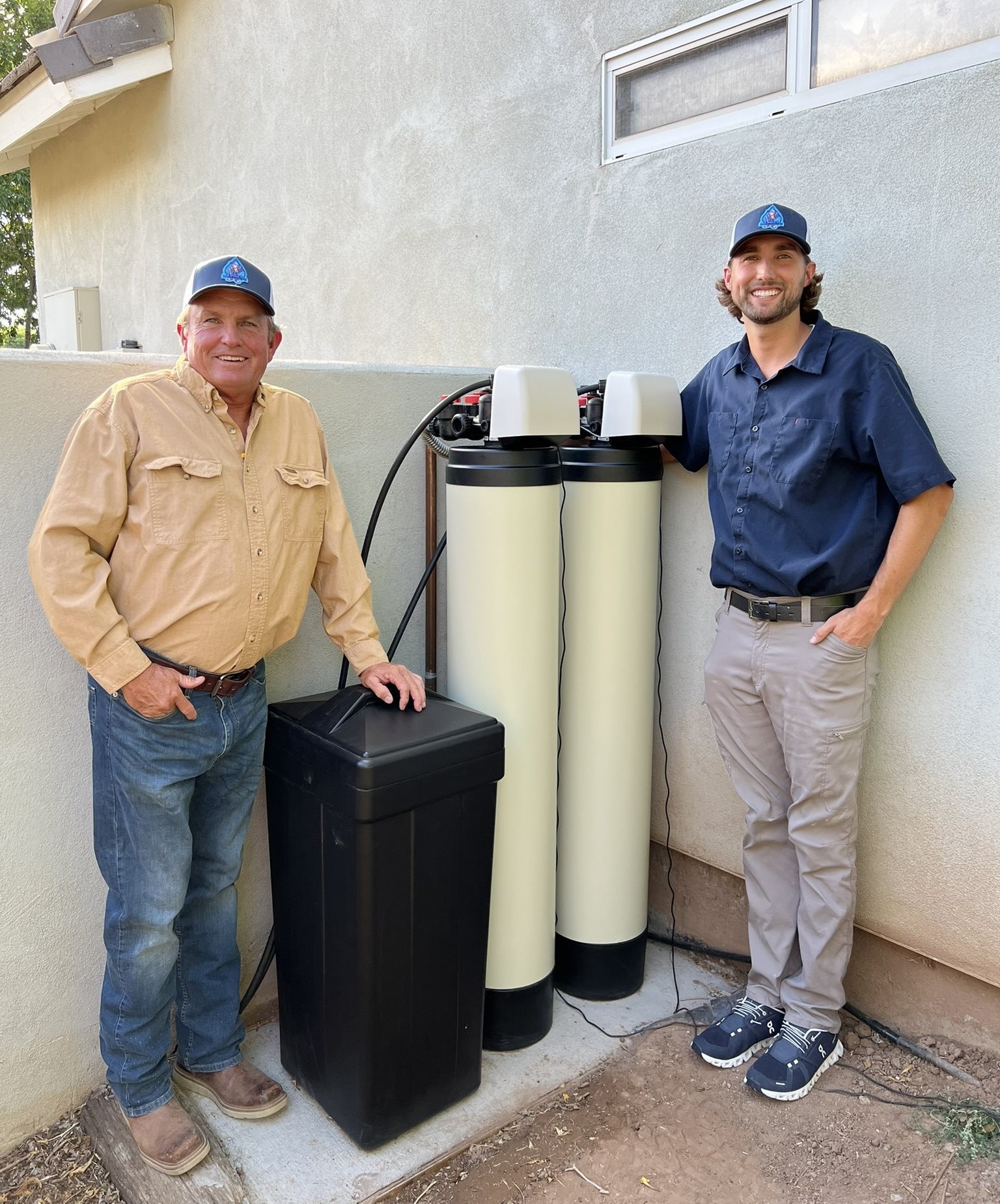 Homeline Plumbing team with completed water filtration installation