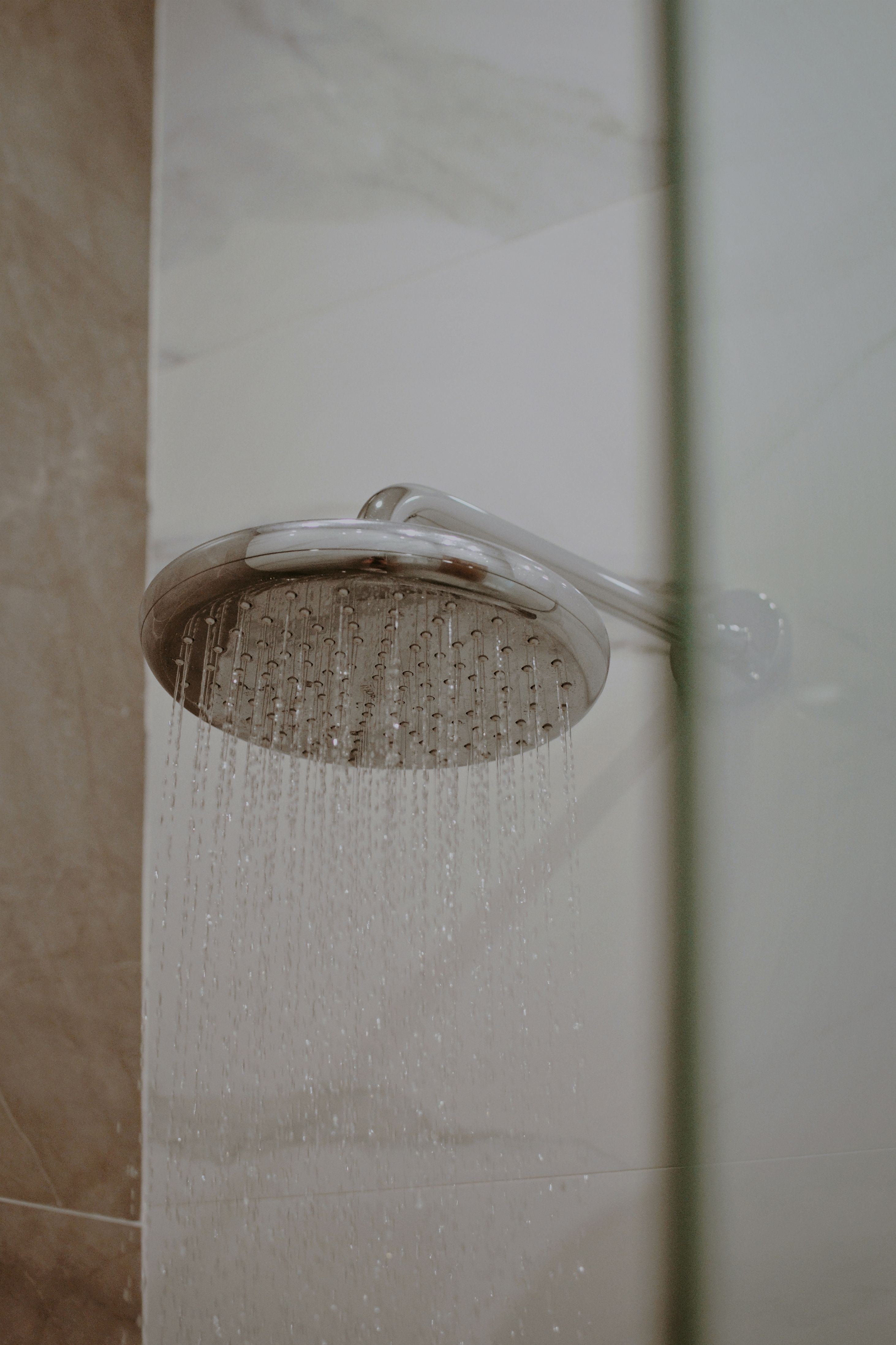 Rain shower head running with softened water